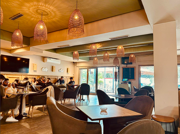 COSTE warm indoor dining room with rattan lamps